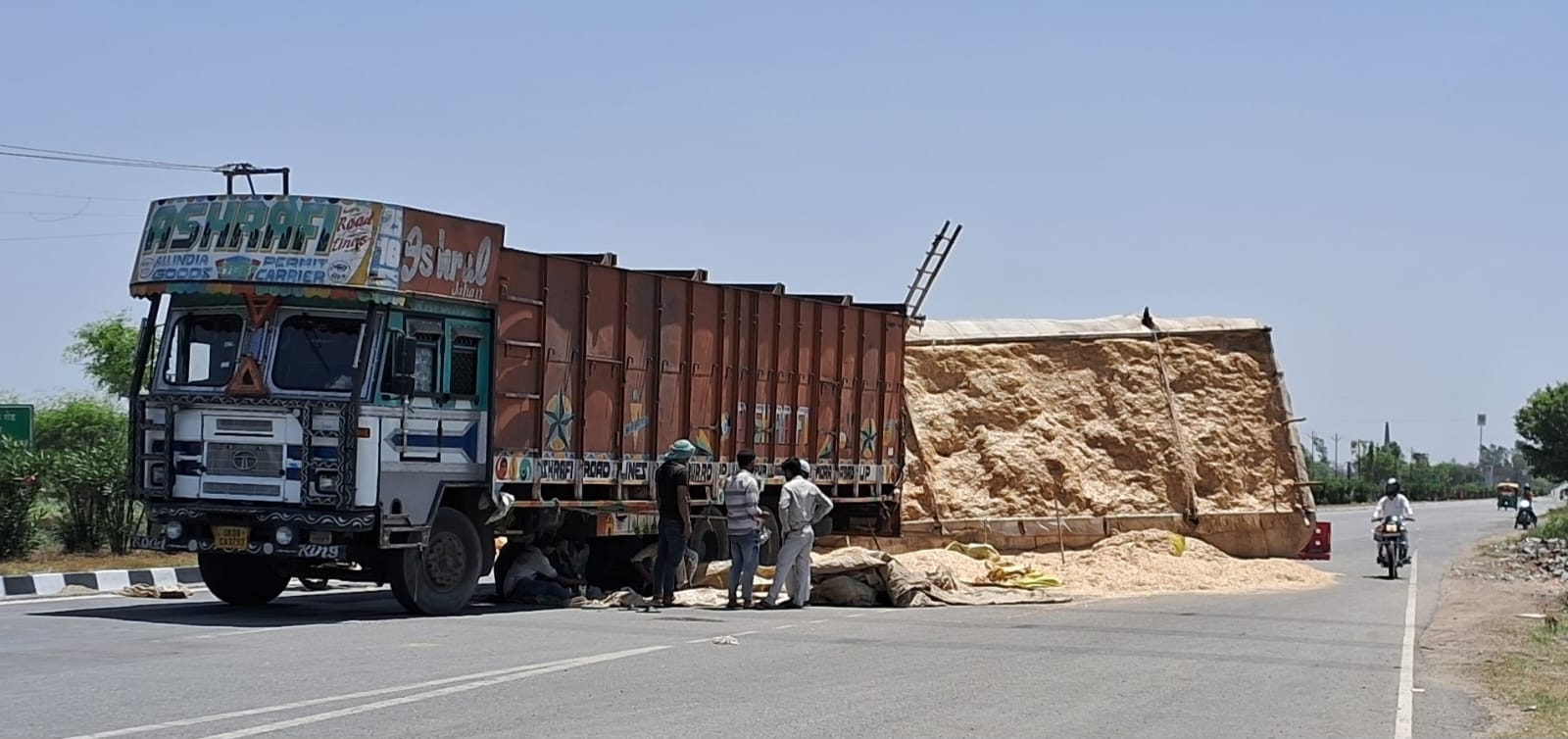 Traffic was blocked for several hours after an overloaded 22 tonne truck filled with straw overturned near Kota on the Saharanpur-Meerut highway